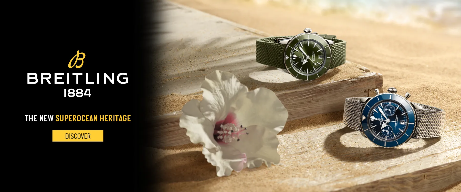 Two Breitling watches on a sandy beach with a flower, promoting the Superocean Heritage collection.