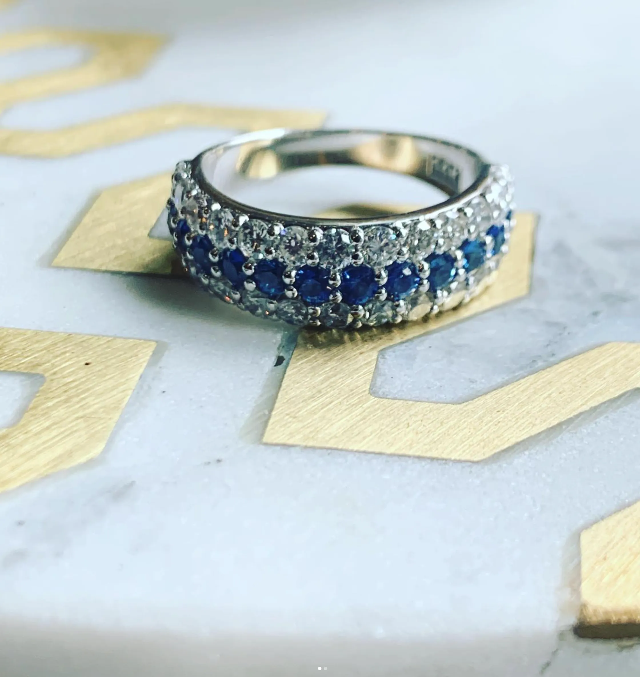 Elegant diamond wedding band and simple silver ring on a neutral surface.