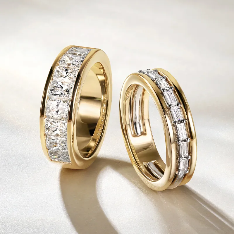 Two elegant gold wedding bands featuring natural diamonds, displayed on a soft background.