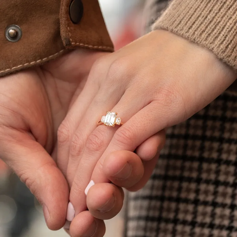 Engagement ring on a couple's hands, showcasing a stunning diamond ring.