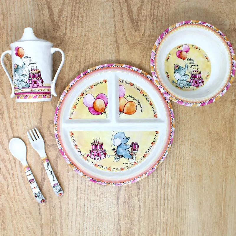 Colorful baby dish set featuring an elephant, balloons, and a cake. Click to explore Baby Cie giftware at Tom Cook Jeweler.