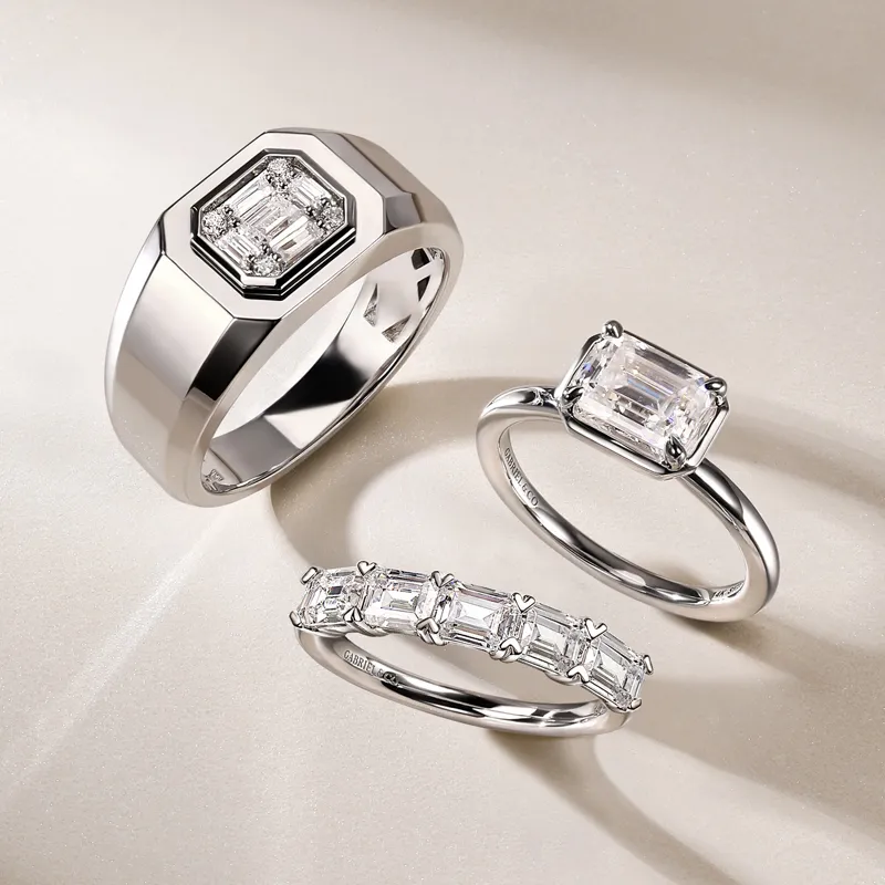 Three elegant diamond rings displayed on a soft surface, showcasing unique designs for wedding bands. Visit Tom Cook Jeweler, In