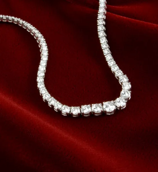 Elegant diamond necklace on red velvet, showcasing fine jewelry from P.J. Rossi Jewelers in Lauderdale-By-The-Sea.