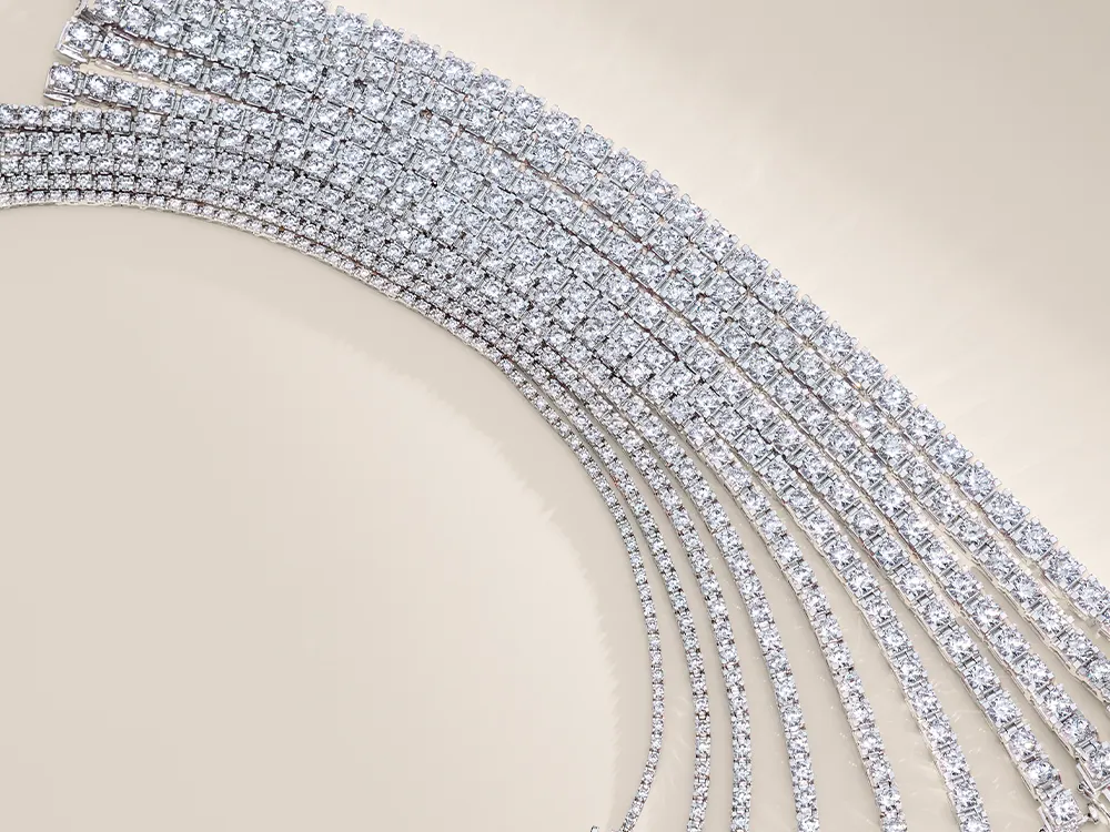 Diamond tennis bracelets arranged in a curved pattern on a beige background.