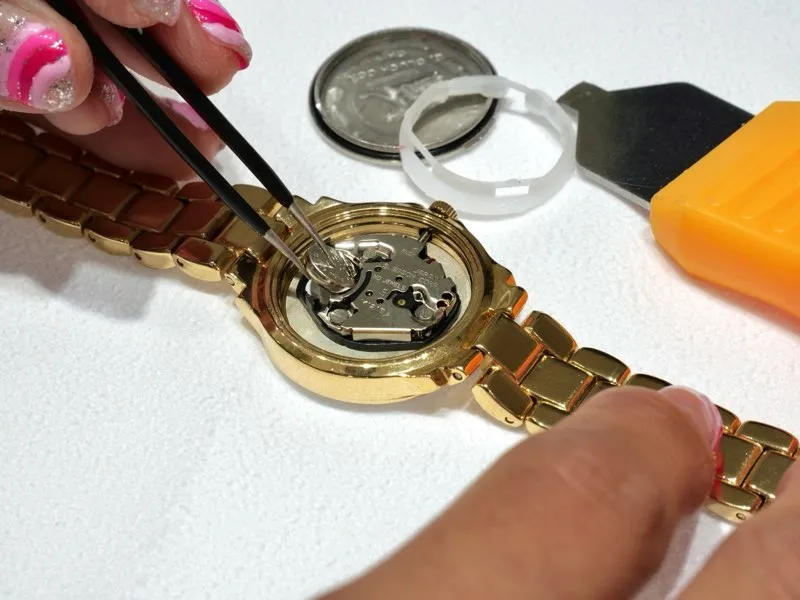 Close-up of a watch repair, showcasing intricate mechanics. Click for watch battery replacement services at Masterpiece Jewelers