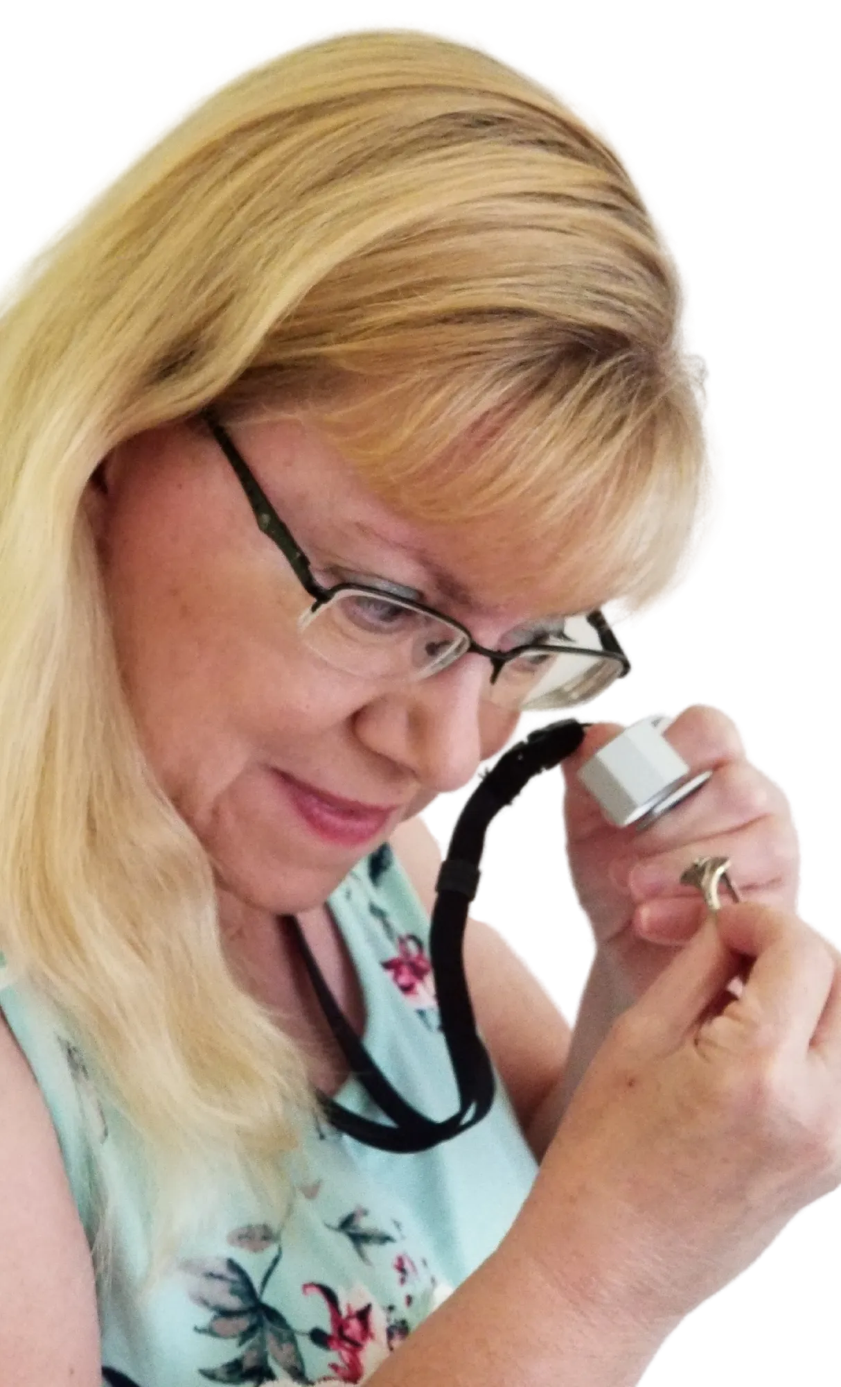 A woman examines a ring with a loupe, promoting free 1-hour jewelry evaluations at Masterpiece Jewelers in Daytona Beach.