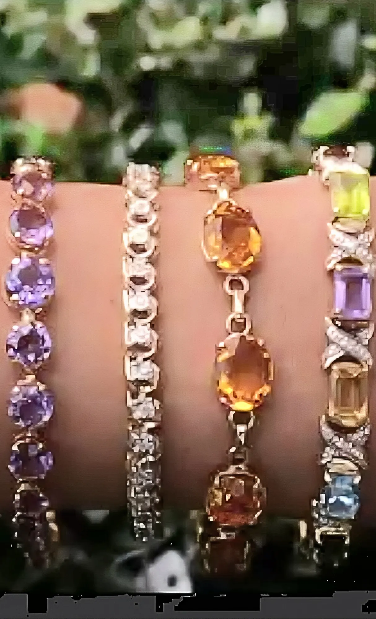 Colorful gemstone bracelets displayed on a hand, showcasing various styles. Click to explore more bracelets at Masterpiece Jewel