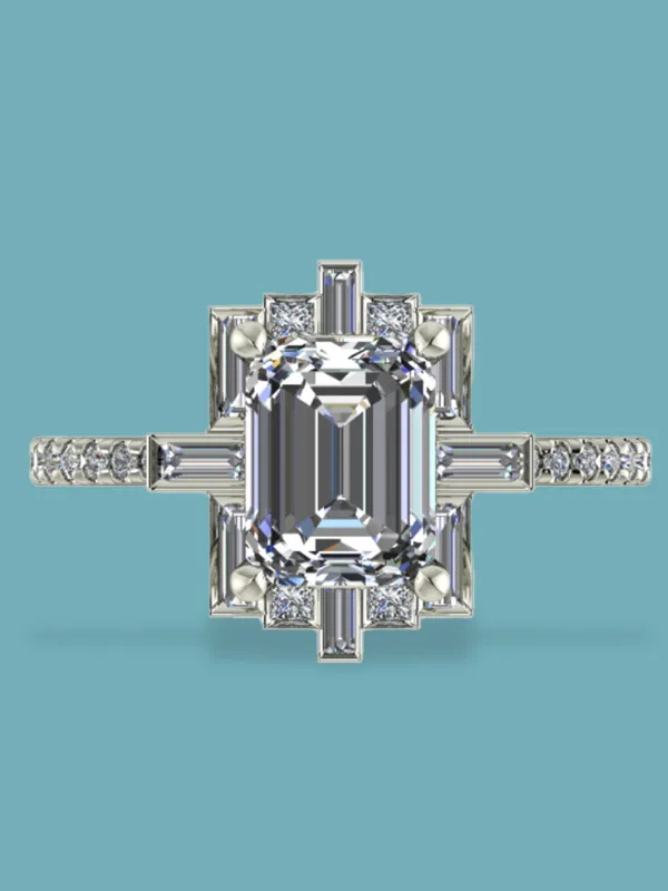 Elegant emerald-cut diamond ring with intricate side detailing, set in white gold. Visit Masterpiece Jewelers in Daytona Beach.