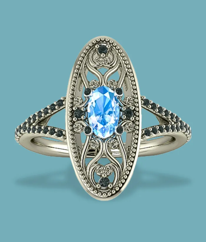Elegant silver ring featuring a blue gemstone and intricate detailing, available at Masterpiece Jewelers in Daytona Beach.