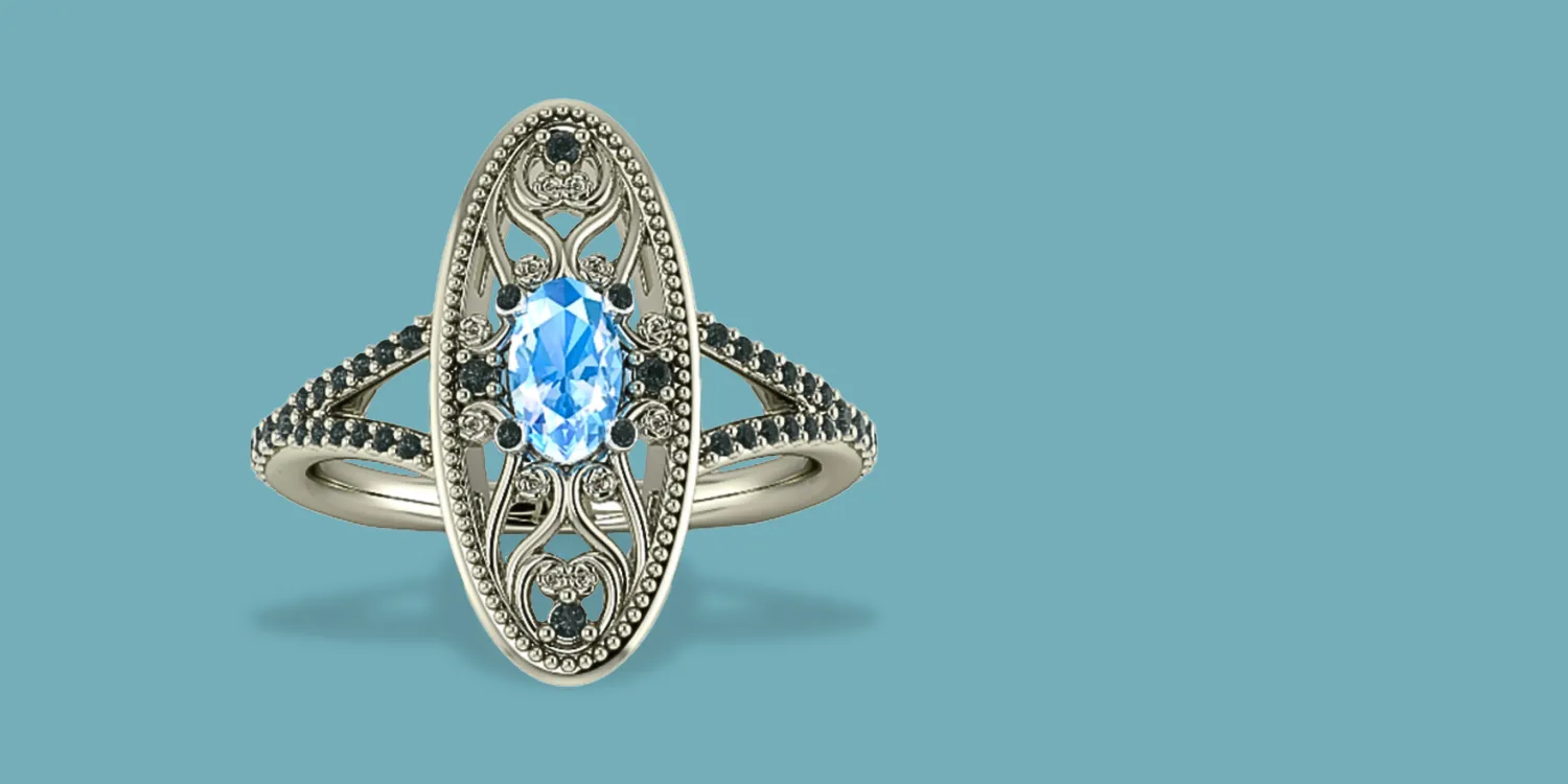 Elegant silver ring featuring a blue gemstone and intricate detailing, available at Masterpiece Jewelers in Daytona Beach.