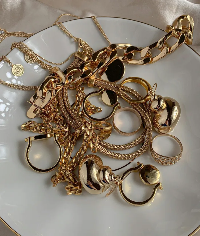 Gold ring with intertwined design and sparkling diamonds, available at Masterpiece Jewelers in Daytona Beach.