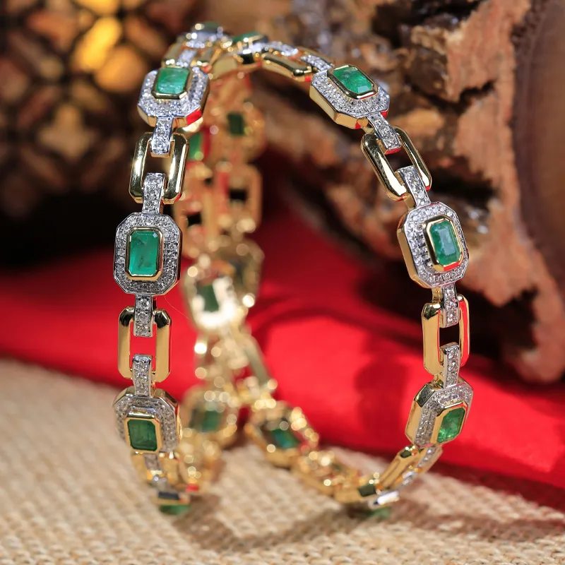 Elegant gold bracelet with green stones and diamonds, perfect for fine jewelry lovers. Visit Masterpiece Jewelers