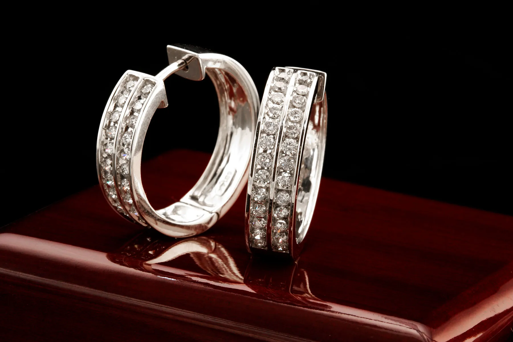 Diamond earrings, including diamond studs, diamond hoops, diamond dangling earrings, and more at Castle Couture Fine Jewelry Man