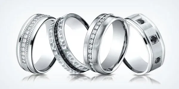 Gift box with red ribbon on wooden table, inviting to shop gifts under $500 at Fairfield Center Jewelers.