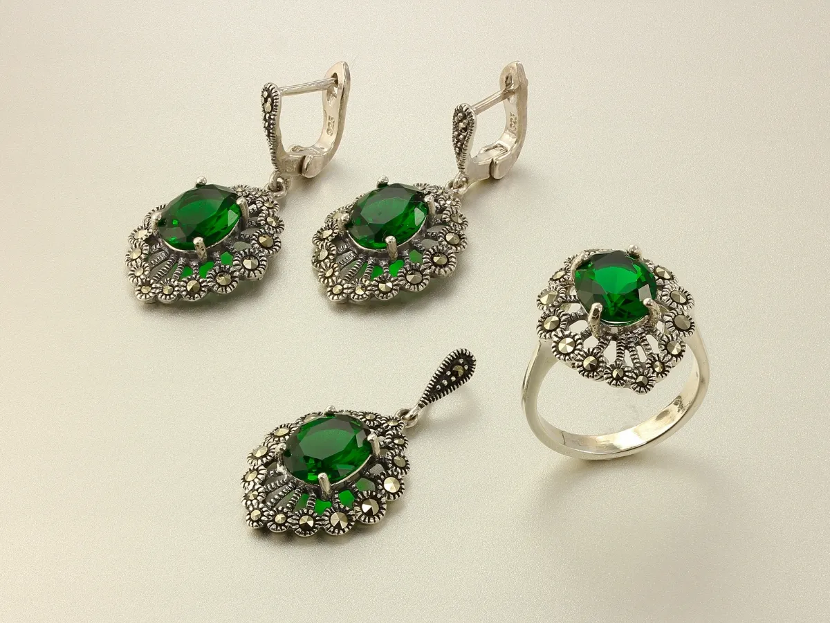 Antique silver jewelry set with emerald stones.