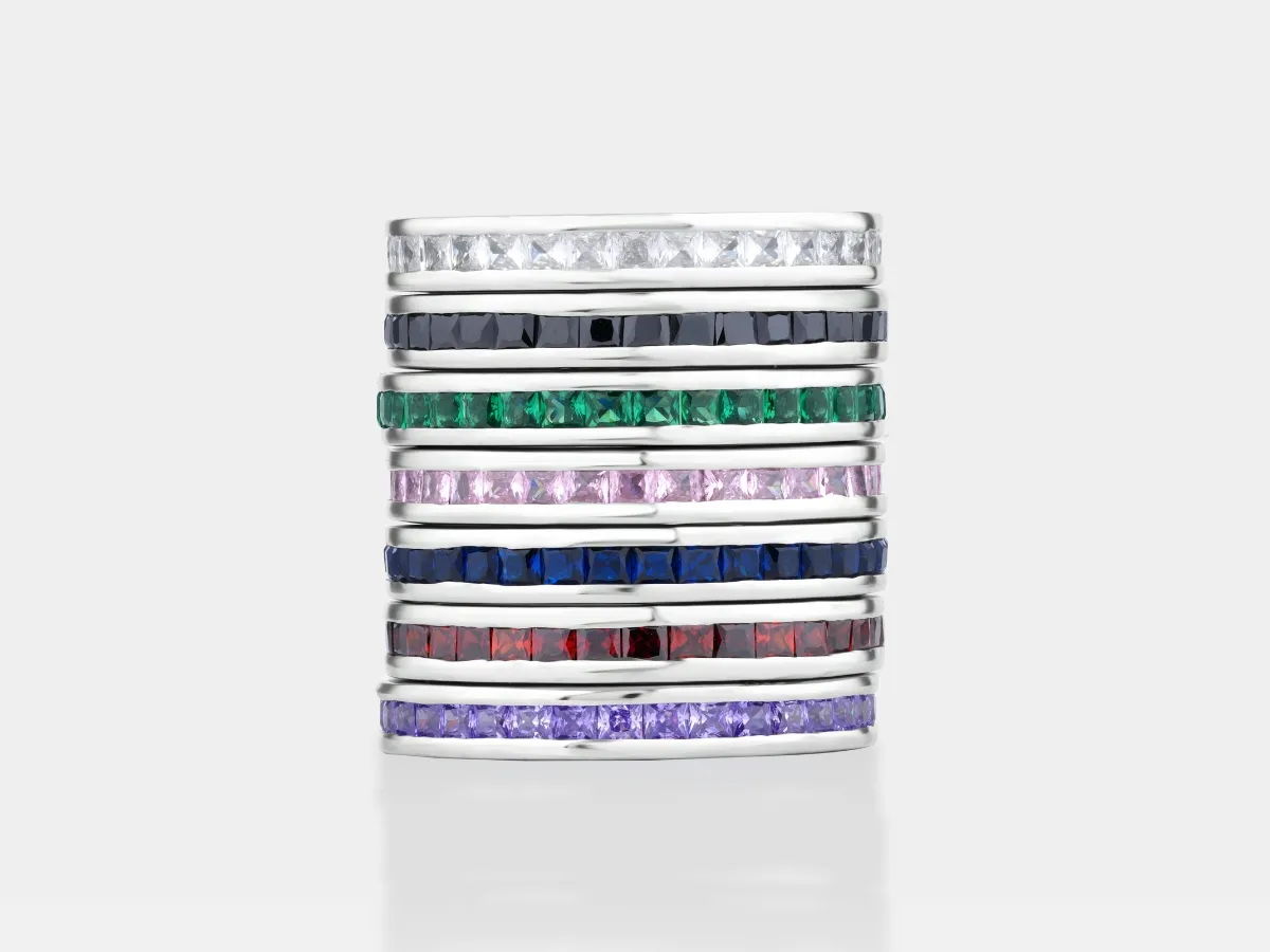 Square-cut gemstones set in white metal bands.