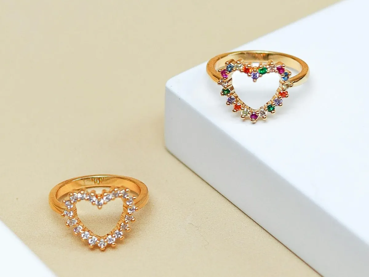 Gold heart rings with clear, colorful gems.