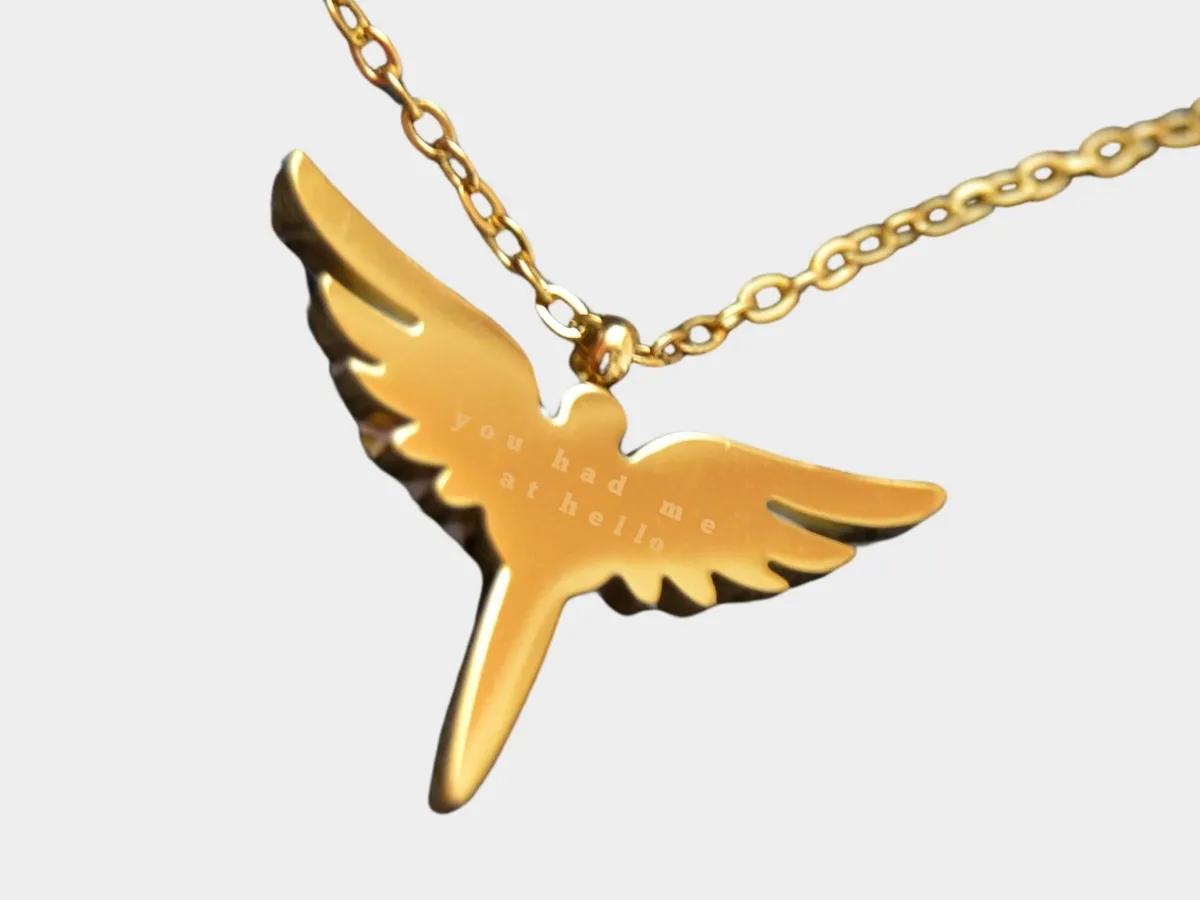 Gold wing pendant necklace engraving.