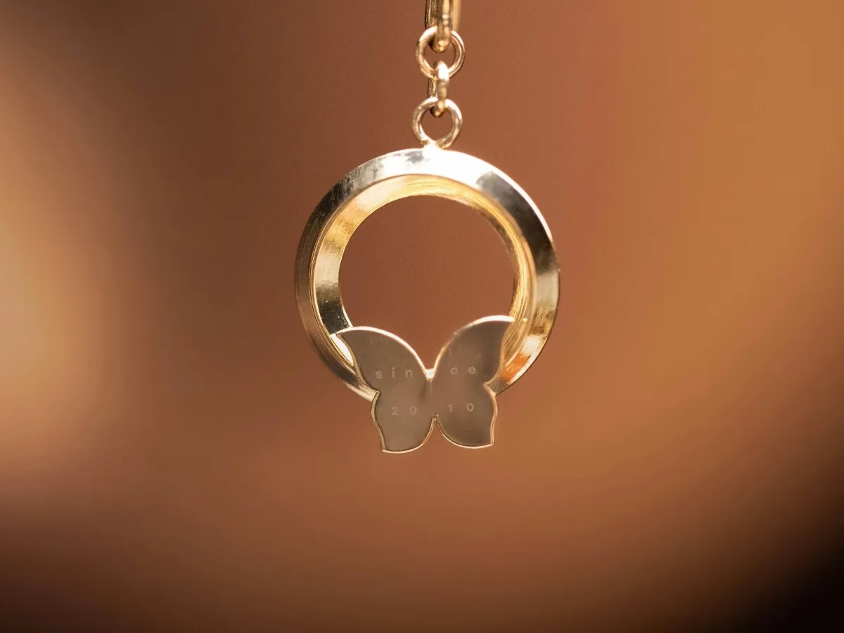 Butterfly charm circular pendant.