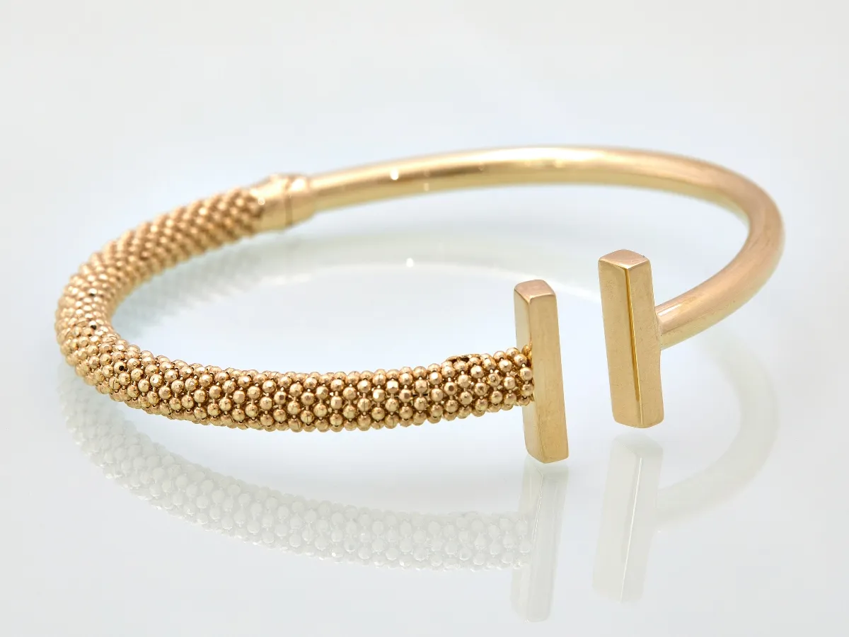 Modern open cuff gold bracelet.