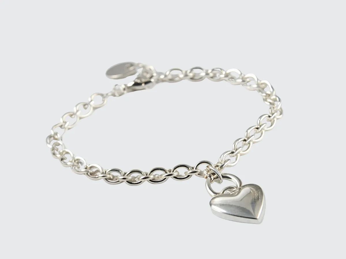 Silver chain bracelet with heart charm.