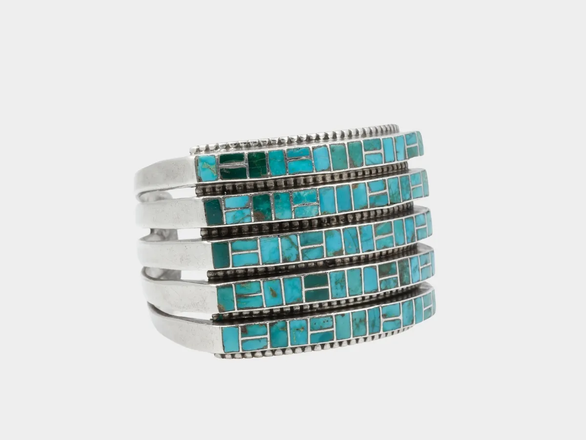 Silver cuff with turquoise inlay.