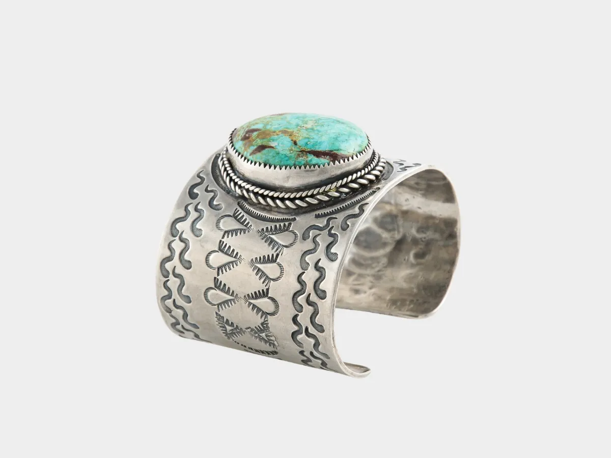 Wide silver cuff with turquoise.