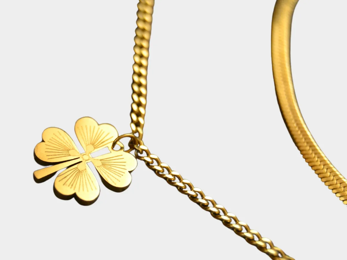 Gold necklace with clover pendant.