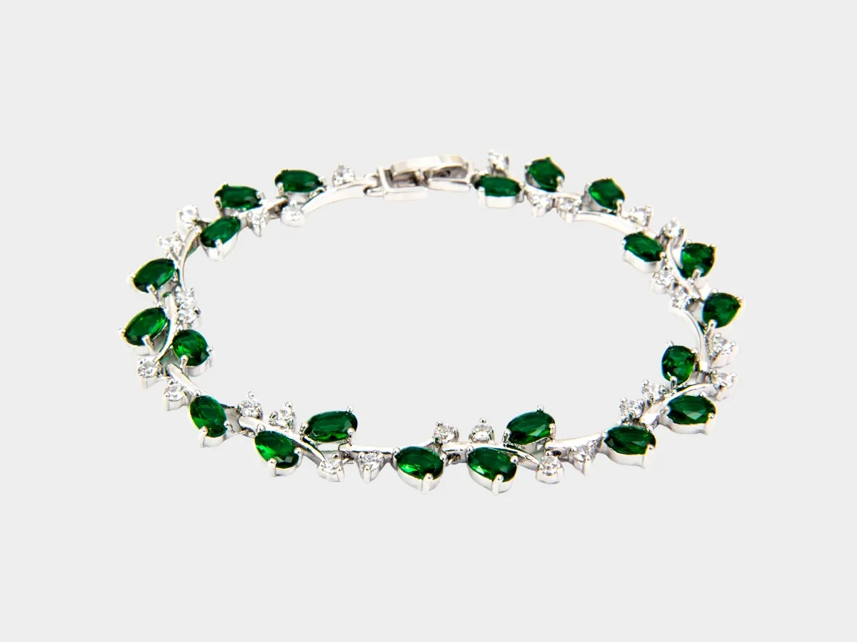 Silver bracelet with green gemstones.