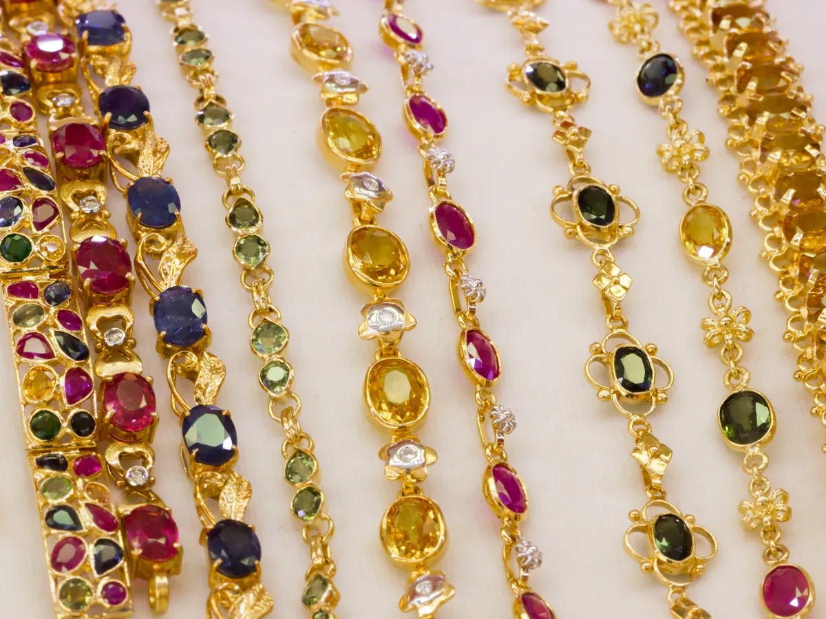 Colorful gemstone gold bracelets display.