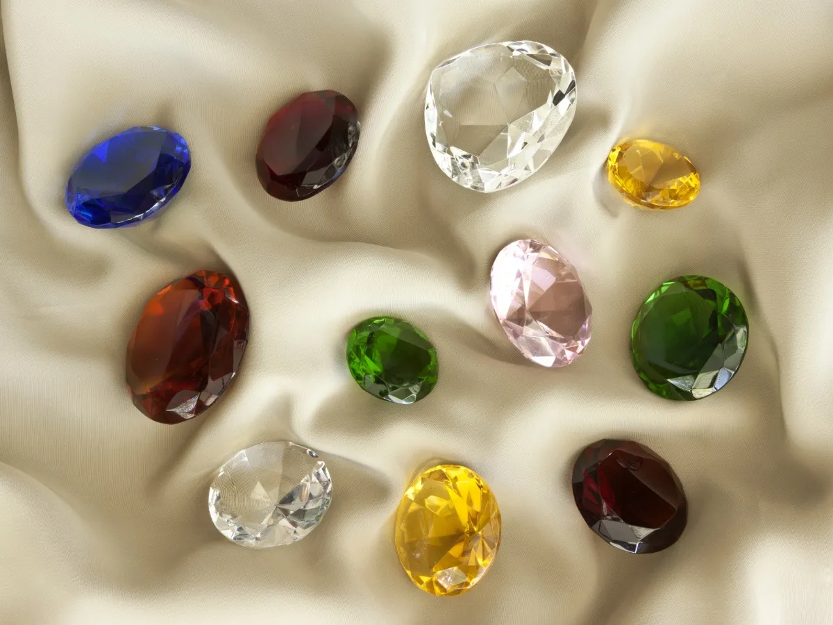 Assorted colorful gemstones on fabric.