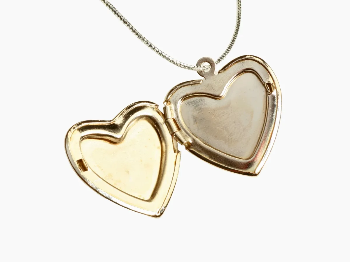 Open heart-shaped gold locket necklace.