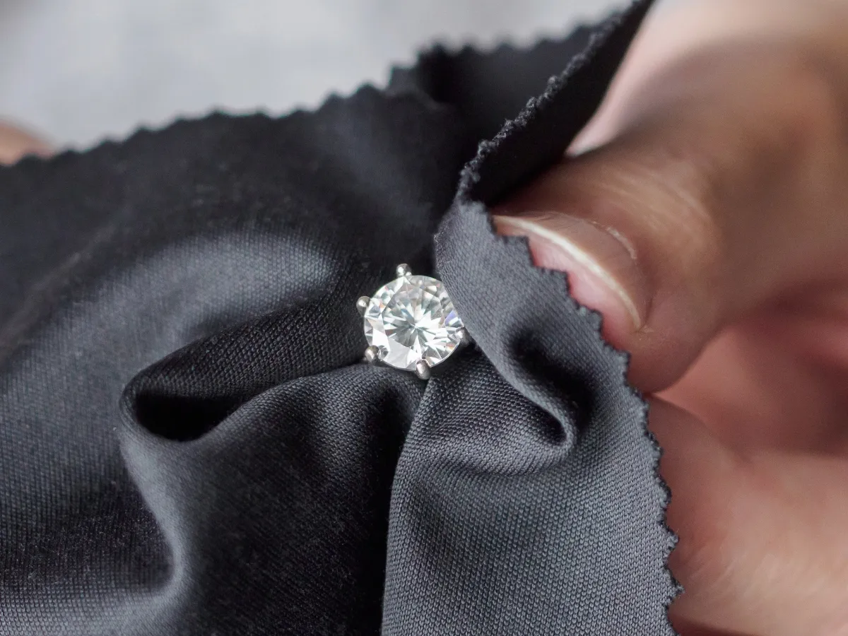 Polishing diamond ring with cloth.