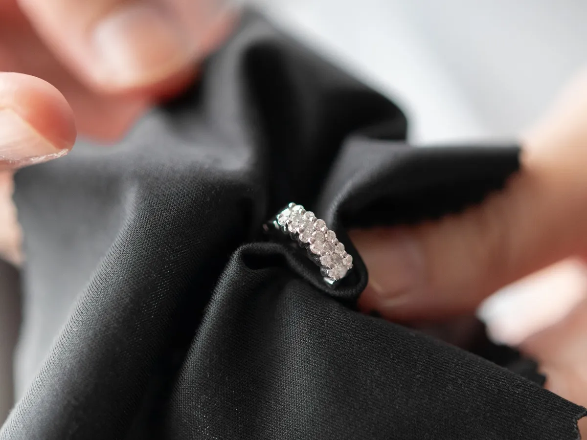 Cleaning diamond band with black cloth.