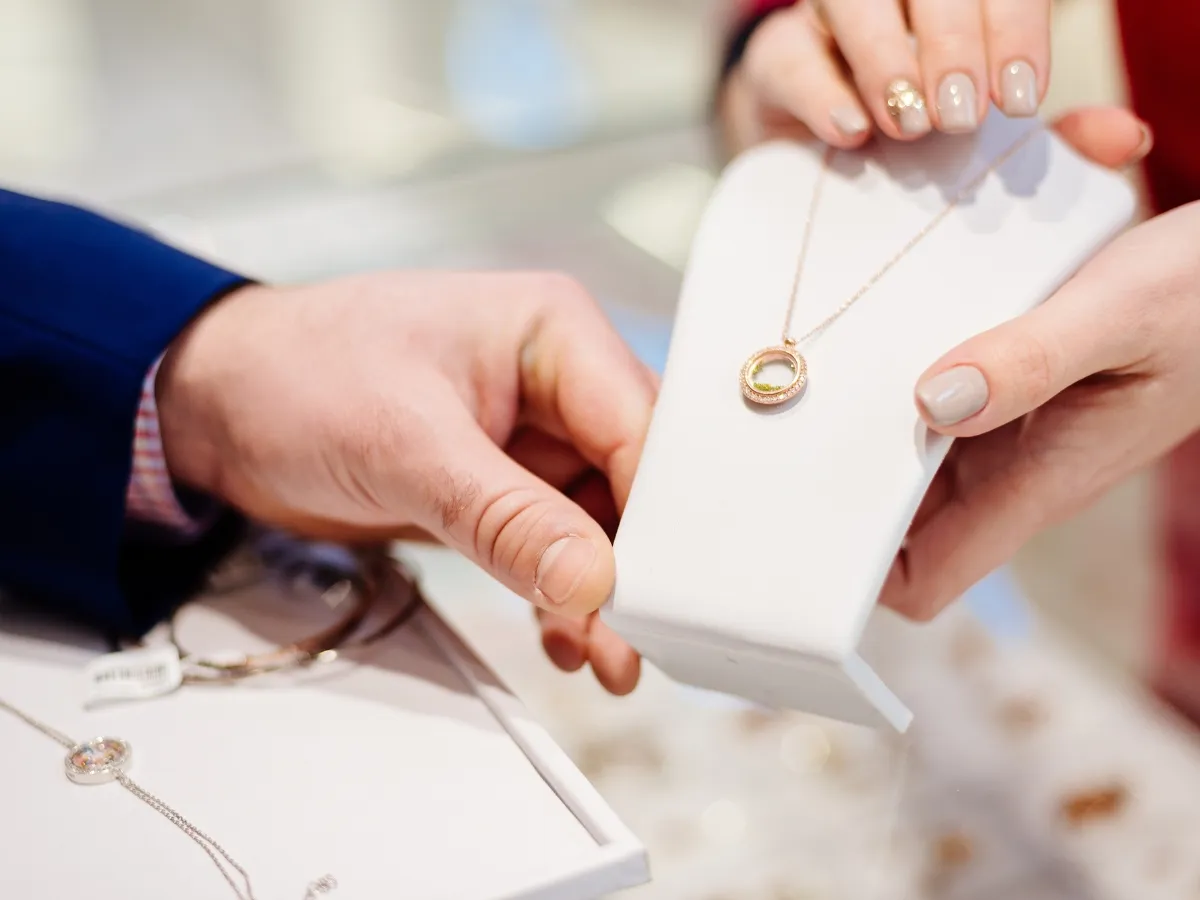Displaying gold necklace on stand.