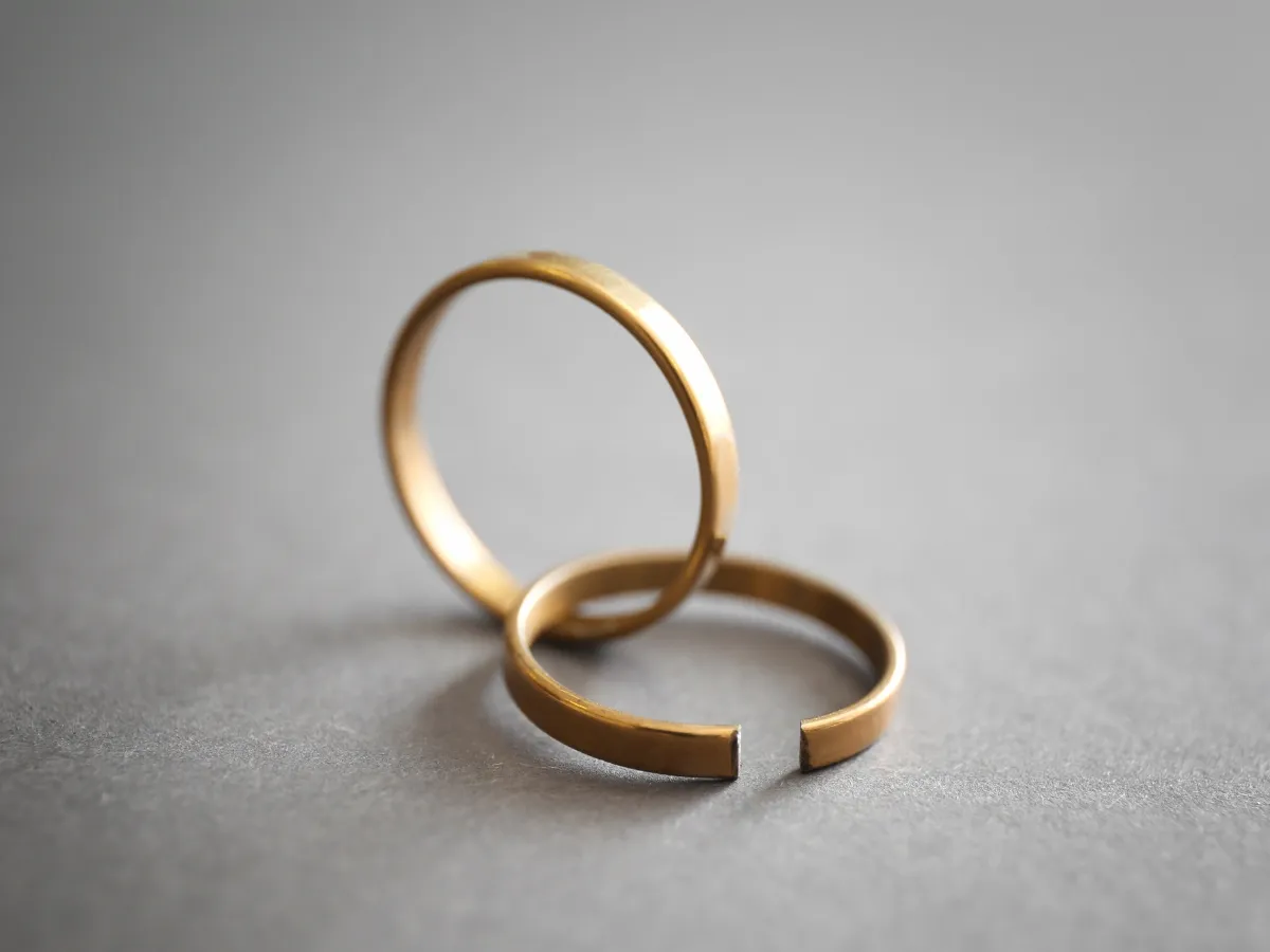 Two separated gold wedding rings.