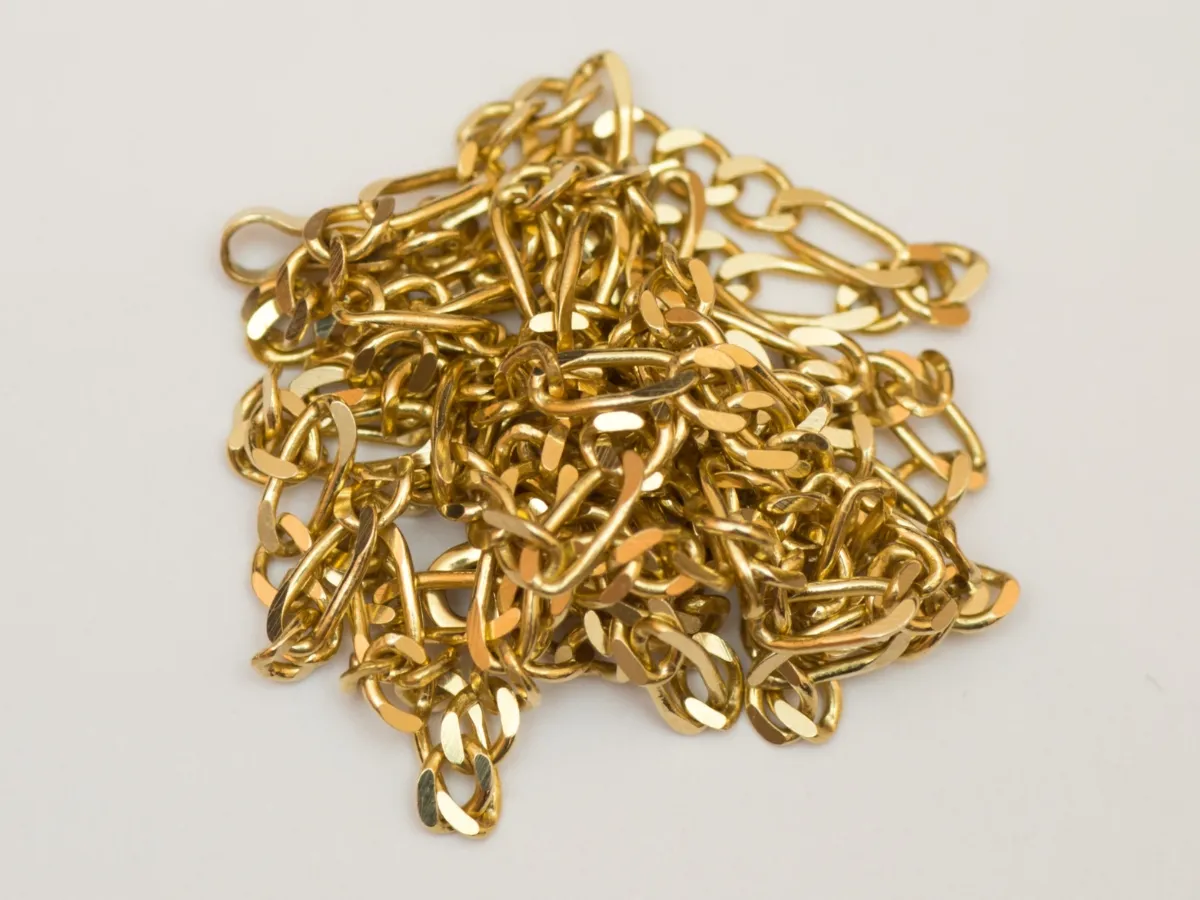 Tangled shiny gold jewelry chain.