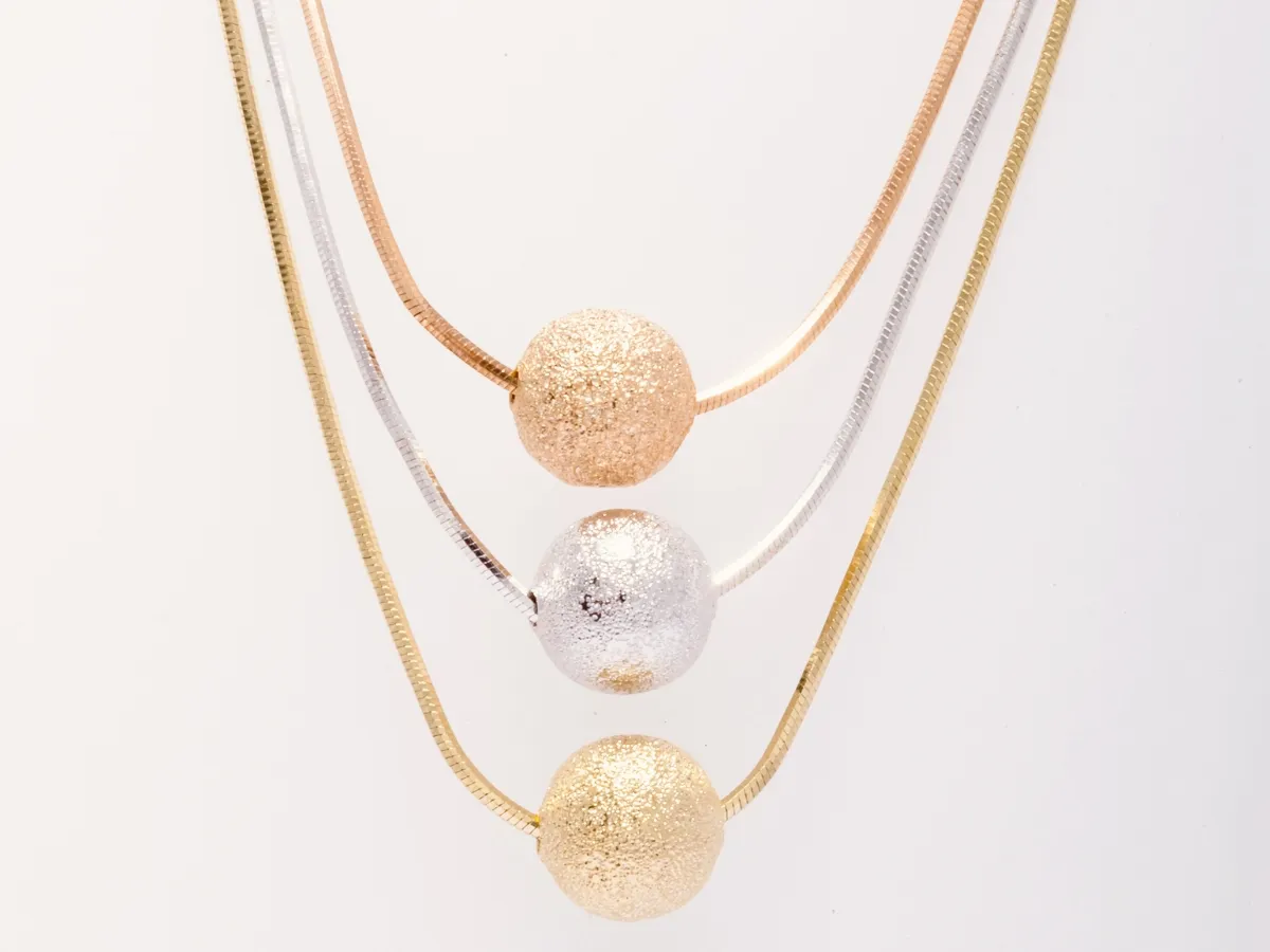 Multicolor herringbone necklaces with textured beads.