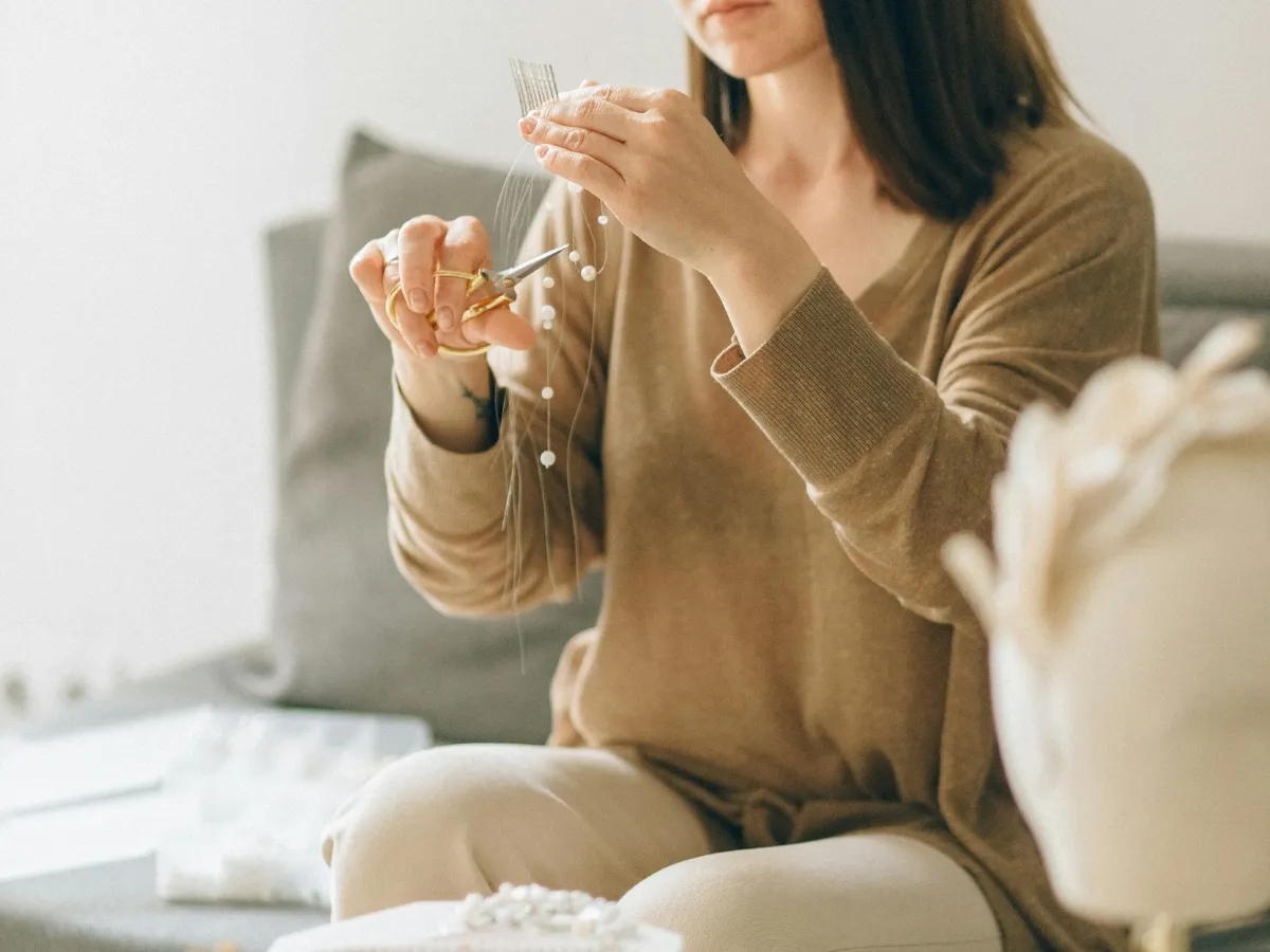 Woman crafting handmade pearl jewelry.