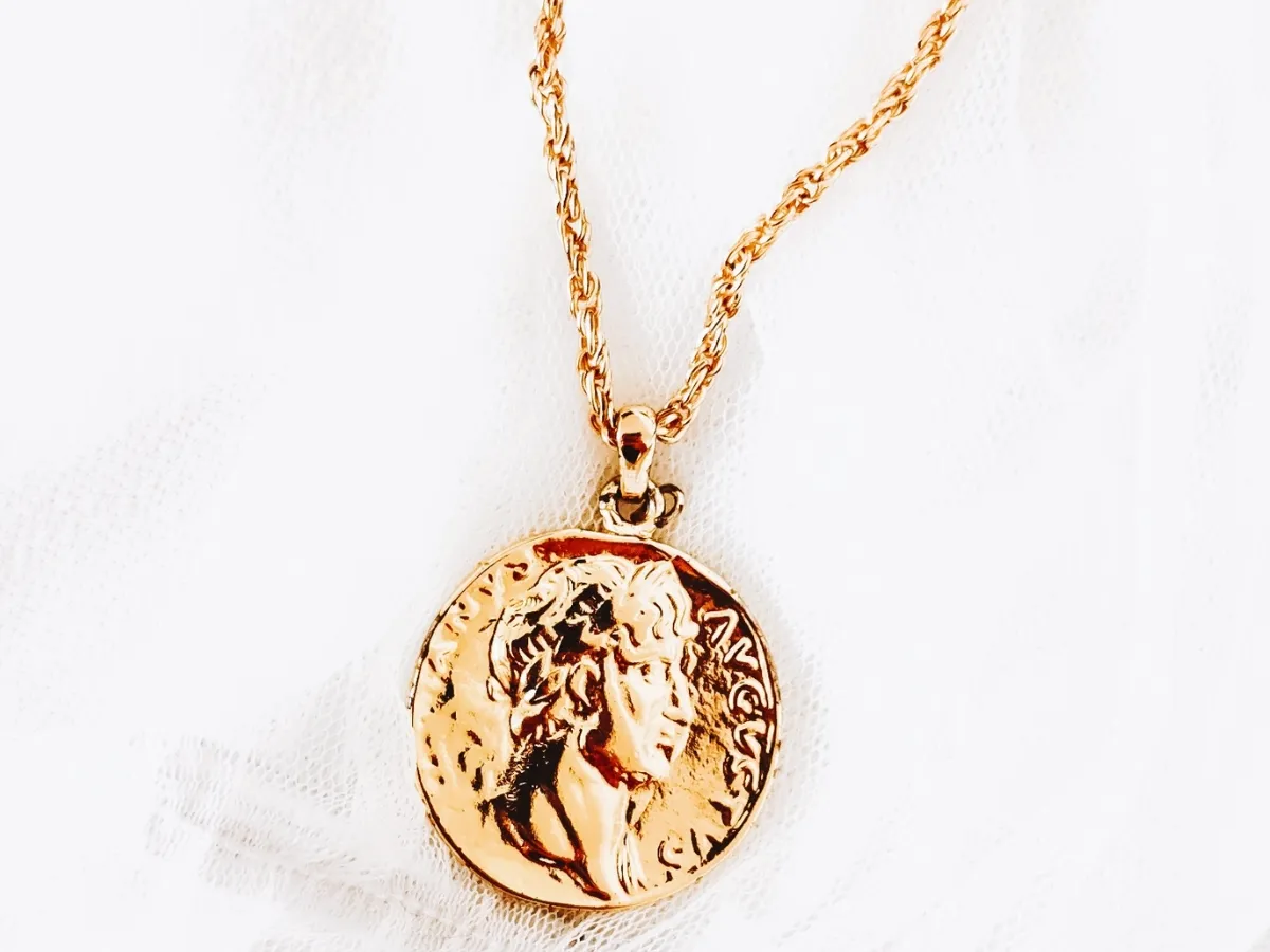 Gold rope chain with coin pendant.