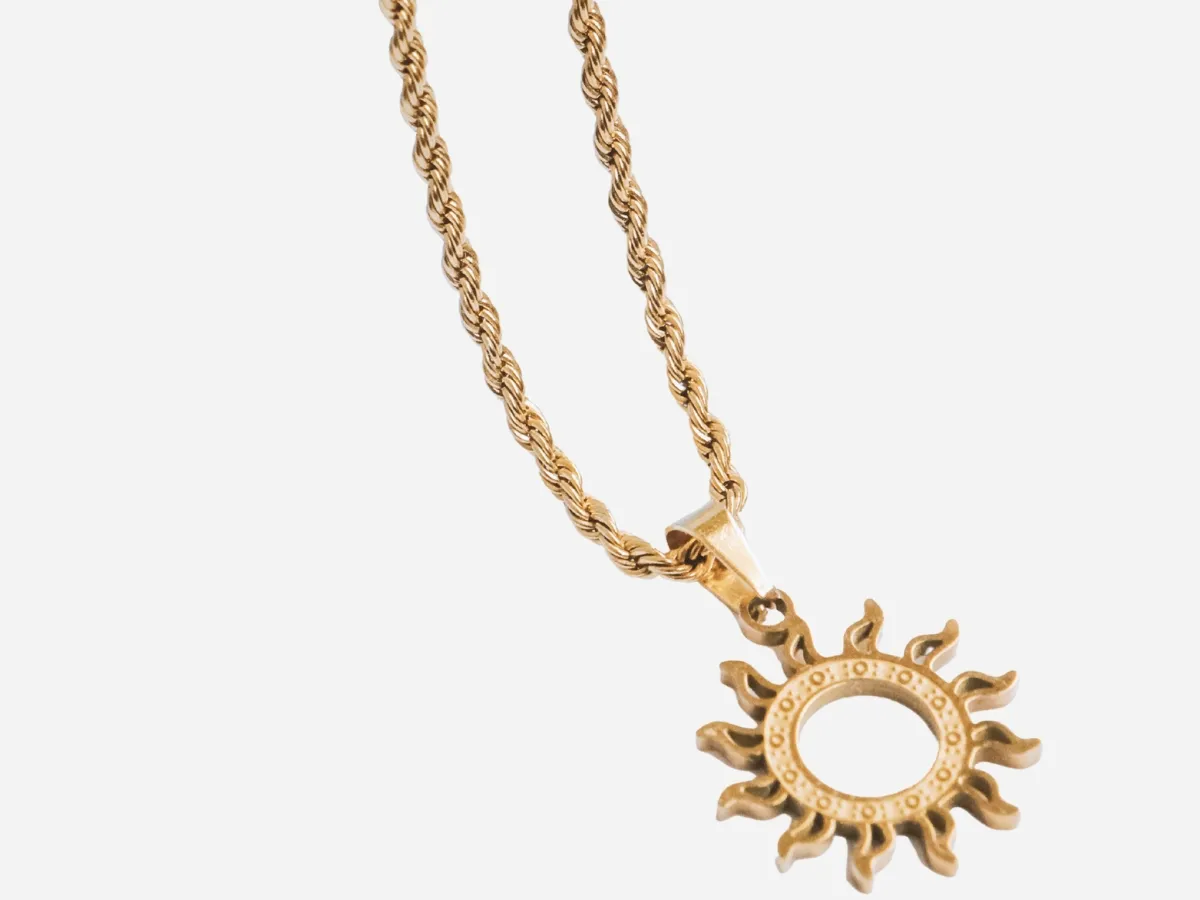Sunburst pendant on rope chain.