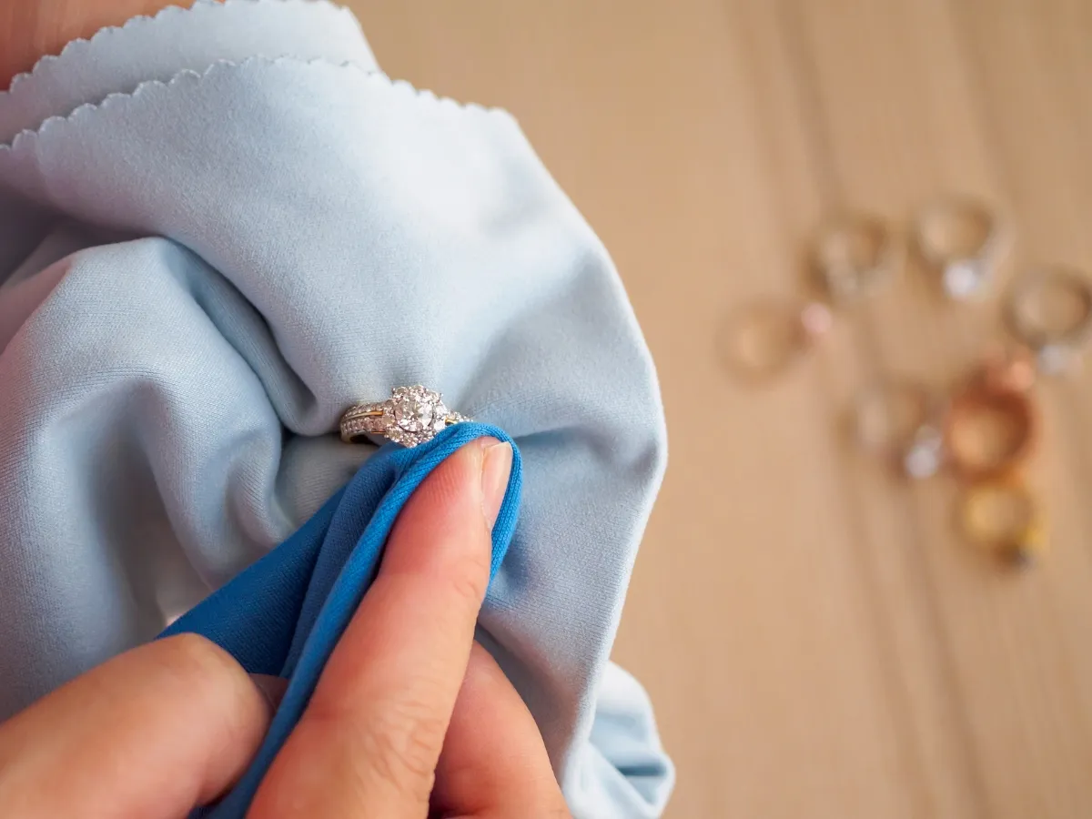 Cleaning diamond ring with cloth.
