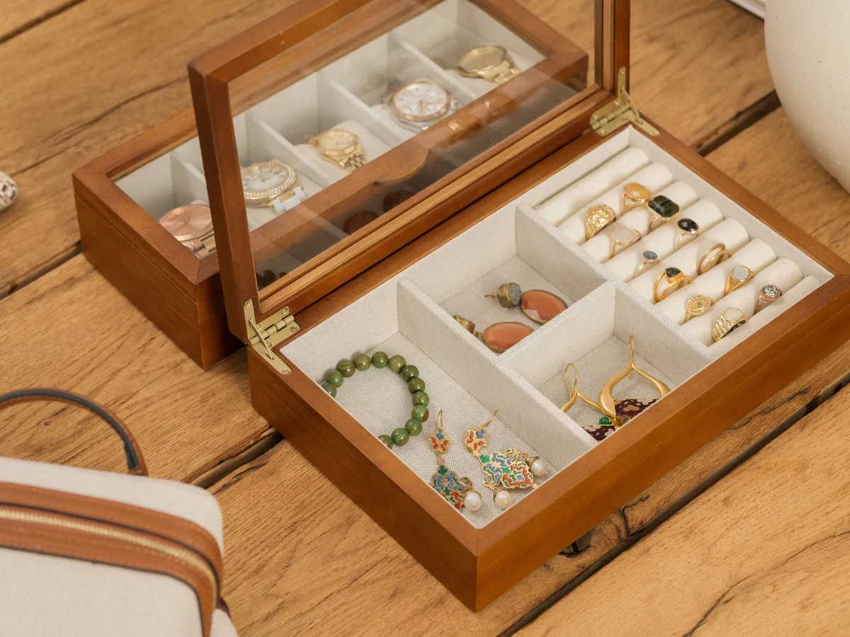 Wooden jewelry box with assorted accessories.