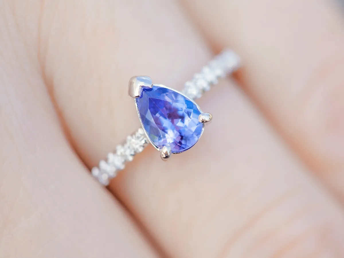 Blue sapphire engagement ring on hand.