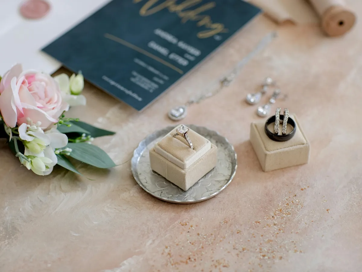 Elegant wedding rings and invitation display.