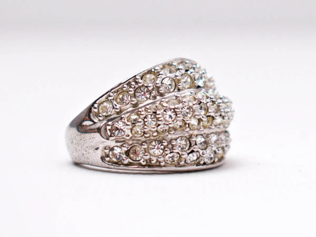 Silver ring with multiple rows of sparkling diamonds.