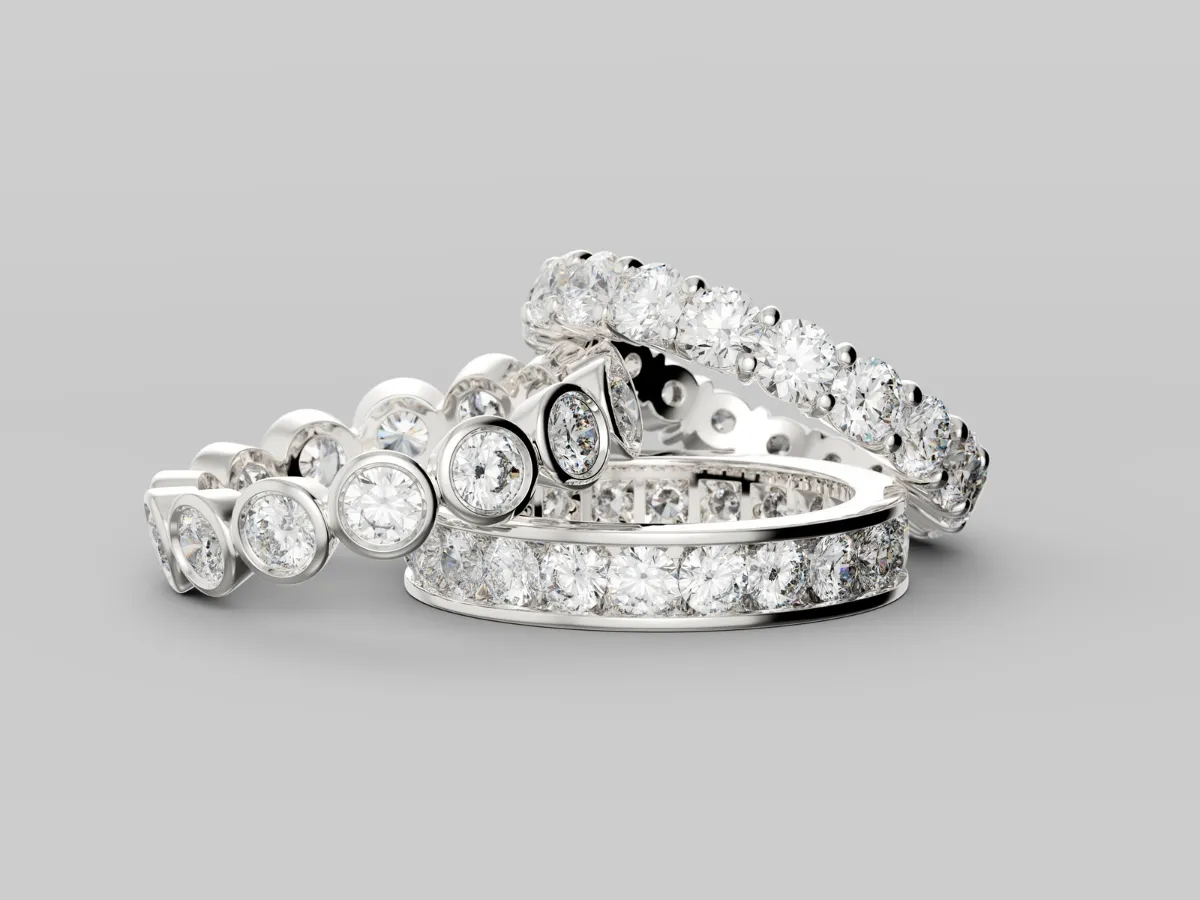 Three elegant diamond eternity rings stacked together.