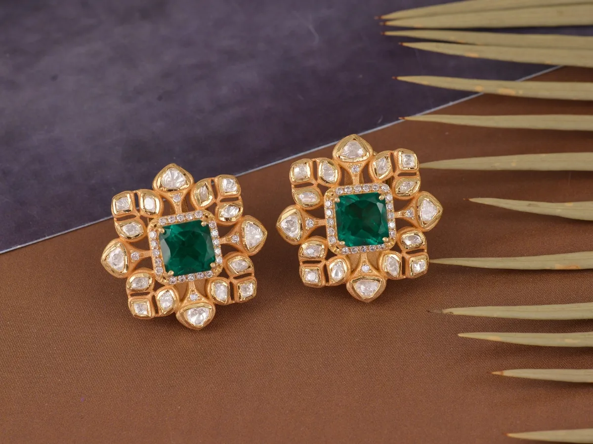 Gold earrings with emerald and diamonds.