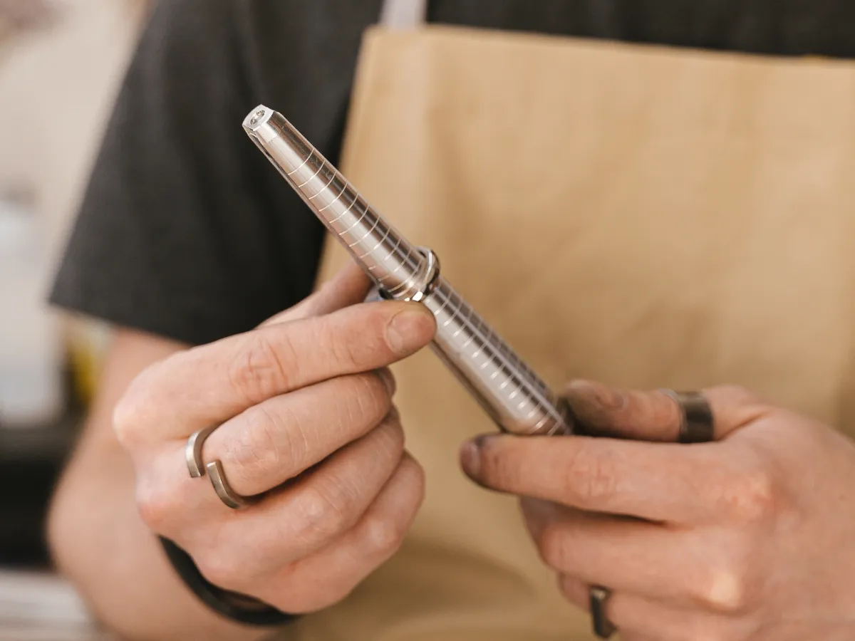 Jeweler measuring ring size with mandrel.