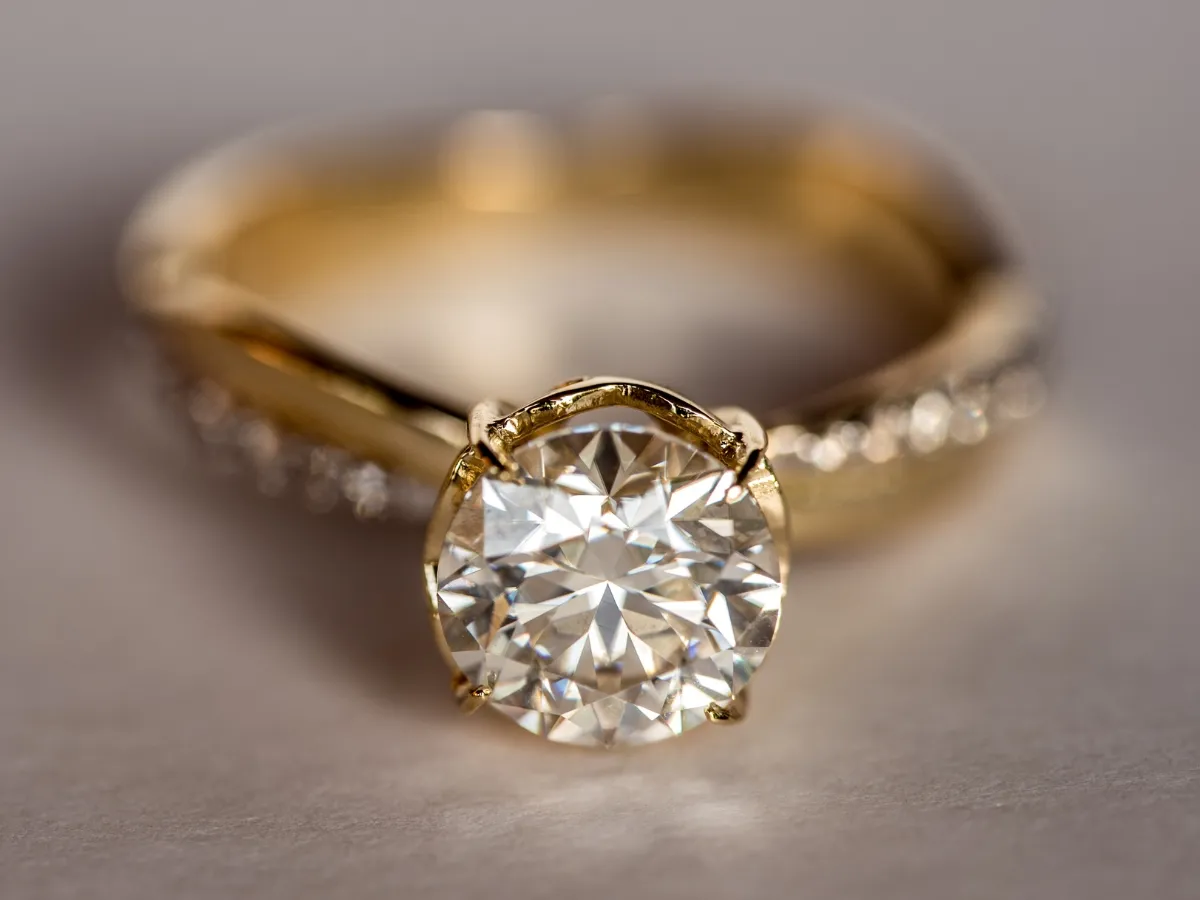 Gold engagement ring with round diamond.